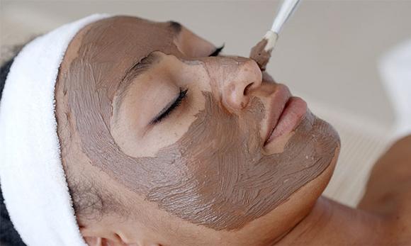 Mud mask facial treatment being applied