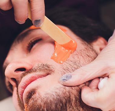 Man having face waxing treatment in Canary Wharf