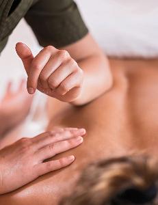 client receiving a deep tissue back massage 
